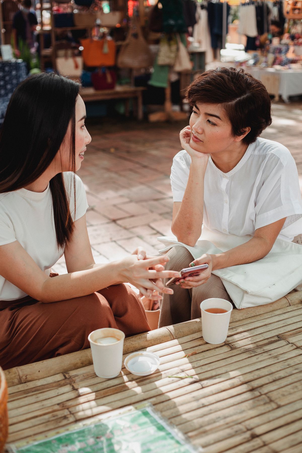 Two people having a thoughtful conversation over coffee