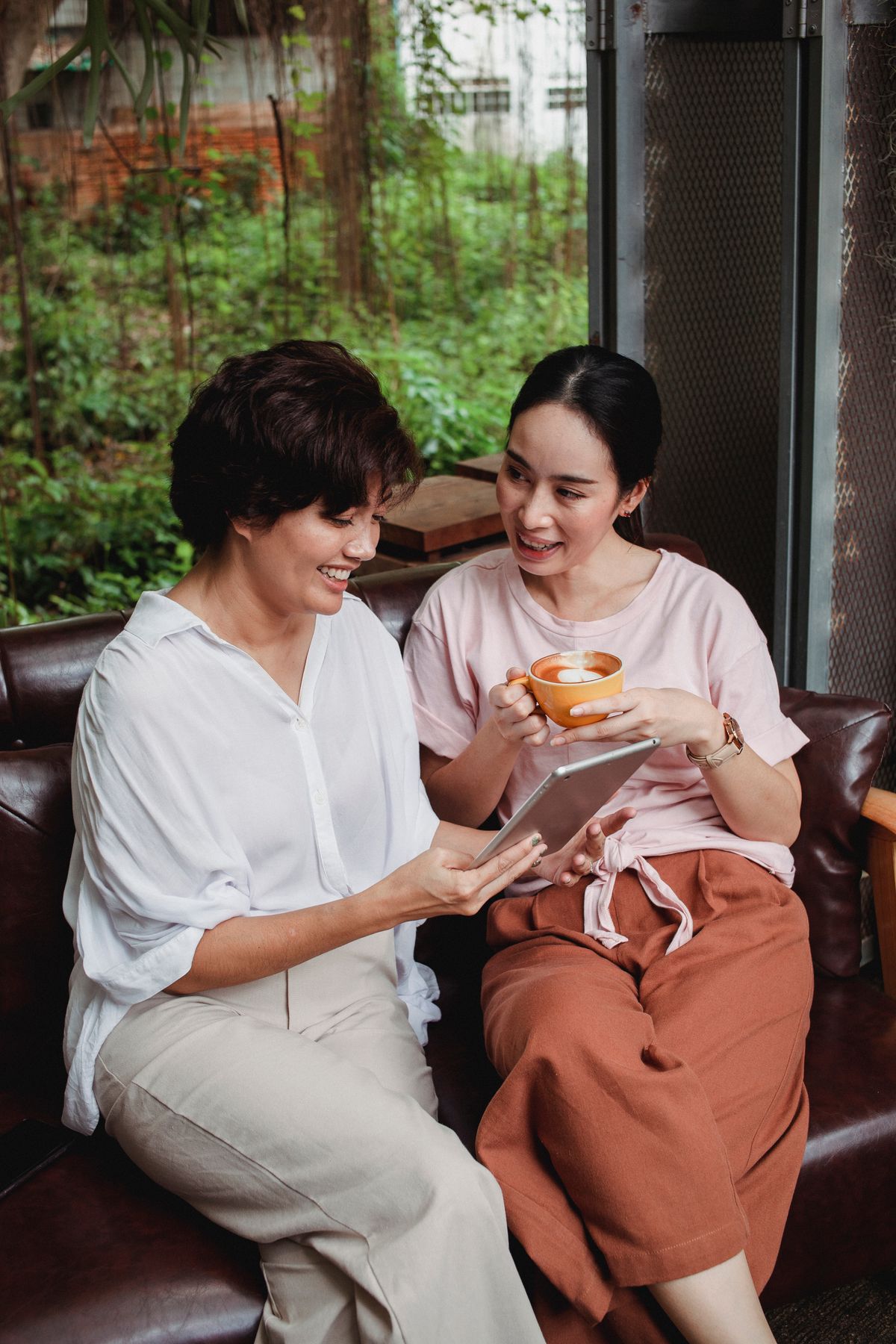 Two people reviewing information together on a tablet